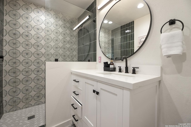 full bath featuring recessed lighting, vanity, and a walk in shower