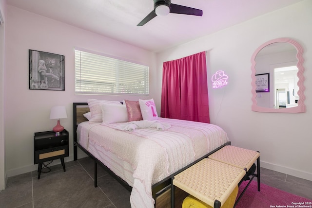 tiled bedroom with a ceiling fan and baseboards