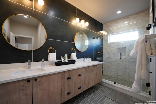 full bath featuring a stall shower, tile patterned flooring, a sink, and double vanity