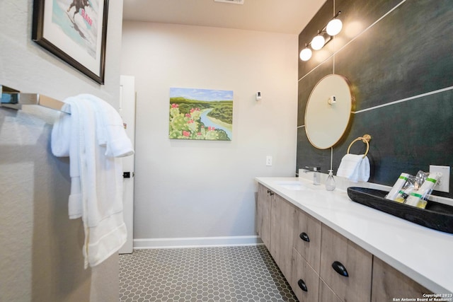 bathroom featuring visible vents, vanity, and baseboards