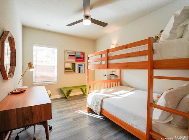 bedroom featuring baseboards and wood finished floors