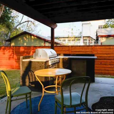 view of patio / terrace featuring fence, grilling area, and an outdoor kitchen