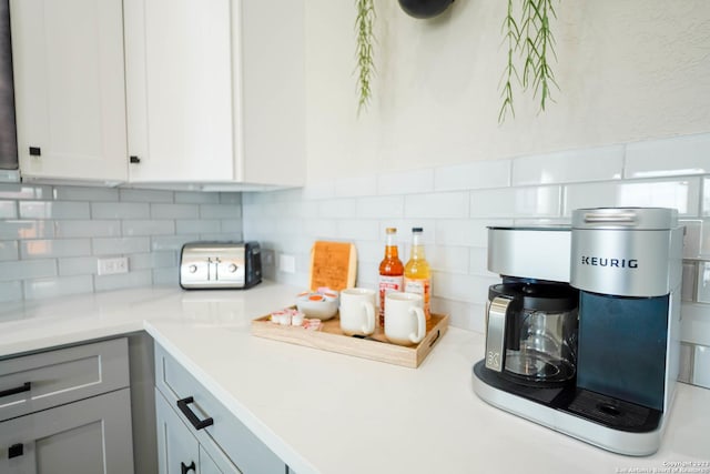 kitchen with gray cabinetry, light countertops, decorative backsplash, and white cabinetry