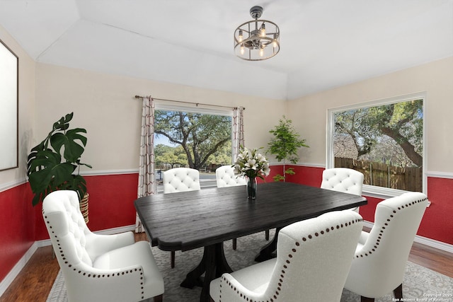 dining room featuring a wealth of natural light, lofted ceiling, and wood finished floors