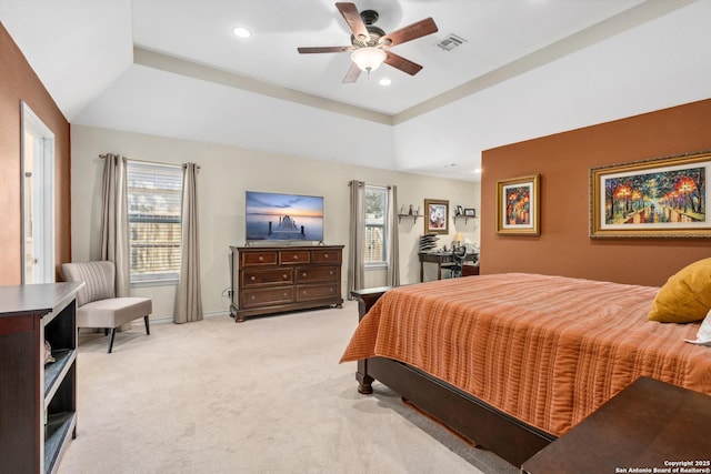 carpeted bedroom featuring baseboards, visible vents, lofted ceiling, a tray ceiling, and recessed lighting