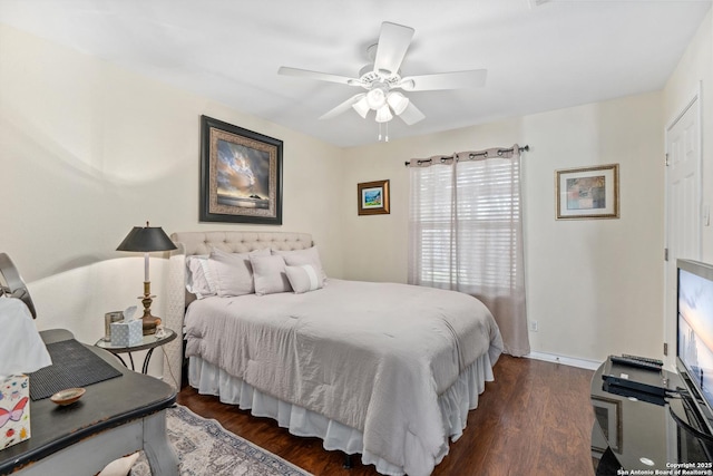 bedroom with baseboards, a ceiling fan, and dark wood-style flooring