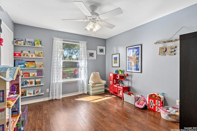 playroom featuring hardwood / wood-style flooring, baseboards, and a ceiling fan