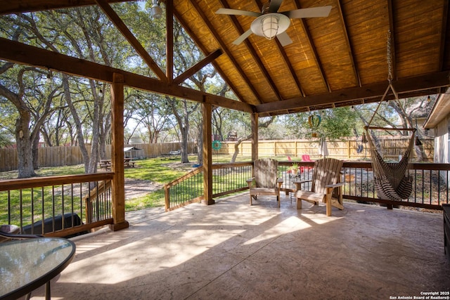 unfurnished sunroom with lofted ceiling and a ceiling fan