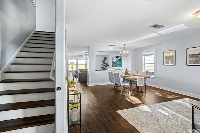 dining area featuring stairway, baseboards, visible vents, and wood finished floors