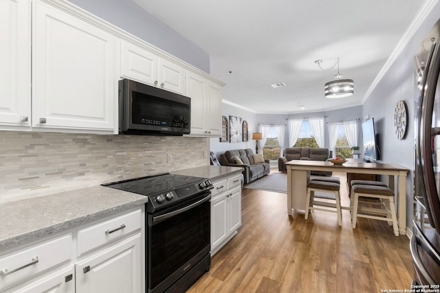 kitchen with crown molding, range with electric stovetop, light wood finished floors, backsplash, and white cabinetry