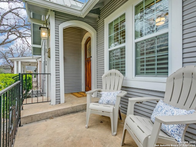 exterior space with a porch and metal roof