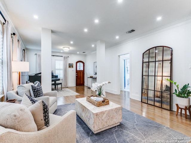 living room with crown molding, visible vents, recessed lighting, and wood finished floors