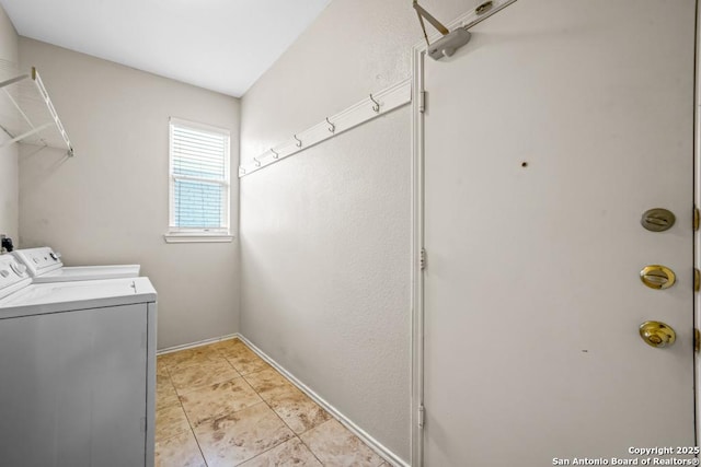 clothes washing area with light tile patterned floors, laundry area, and washing machine and clothes dryer