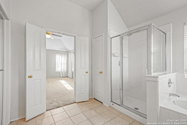 bathroom featuring a stall shower, a garden tub, vaulted ceiling, and tile patterned floors