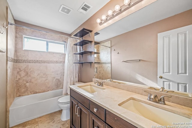 bathroom featuring visible vents, a sink, toilet, and shower / bath combo with shower curtain