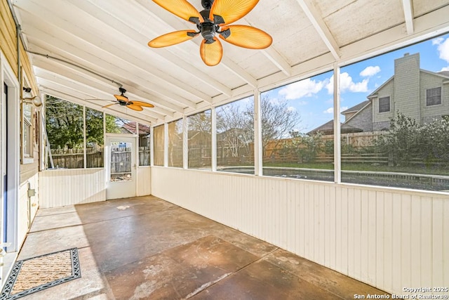 unfurnished sunroom featuring lofted ceiling with beams and a ceiling fan