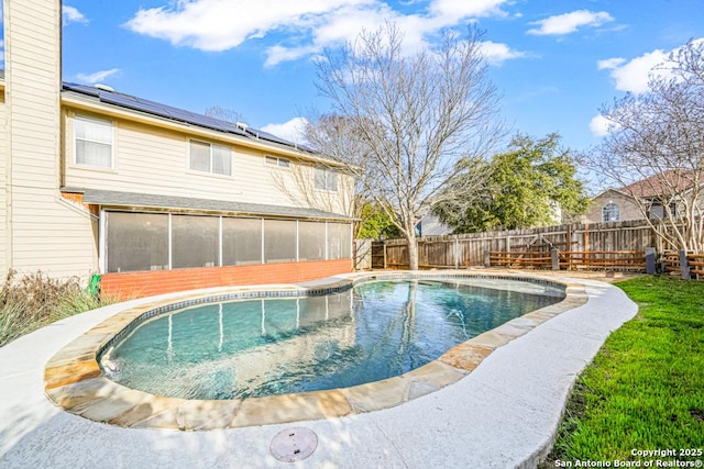 view of pool with a fenced in pool, a sunroom, and a fenced backyard