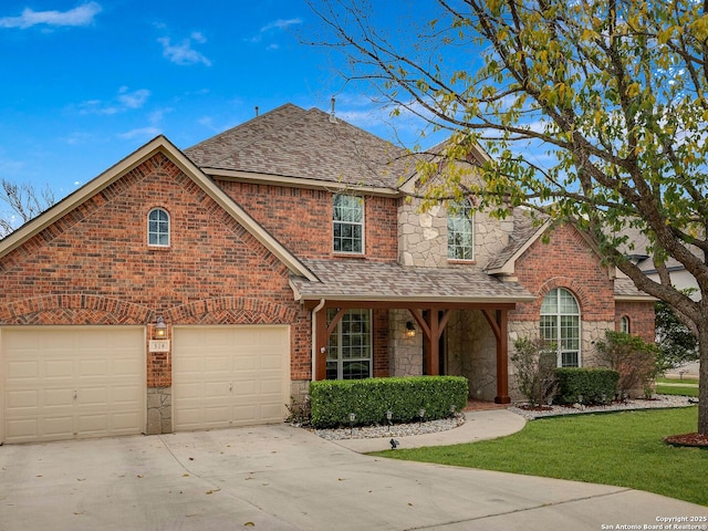 traditional home featuring driveway, a garage, stone siding, roof with shingles, and brick siding