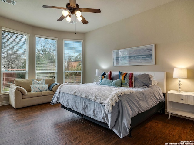 bedroom featuring a ceiling fan, dark wood-style flooring, and visible vents