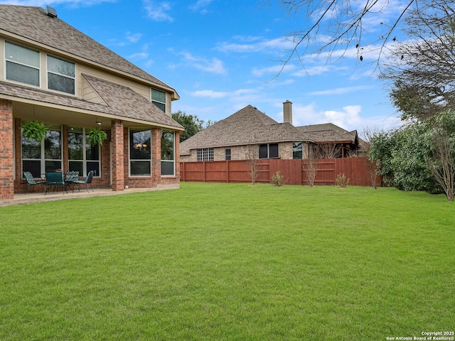 view of yard with fence and a patio