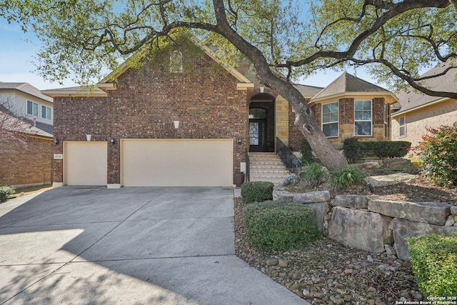 view of front facade with brick siding and driveway