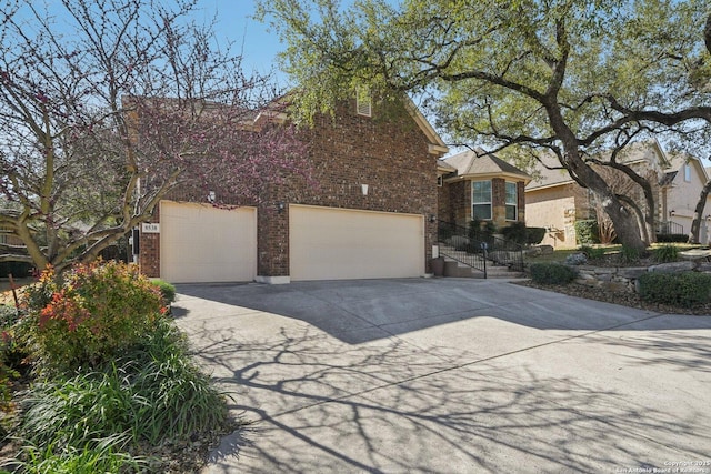 obstructed view of property featuring driveway and brick siding