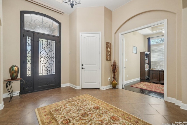 entryway with tile patterned flooring and baseboards