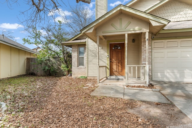 entrance to property with fence, a chimney, and an attached garage