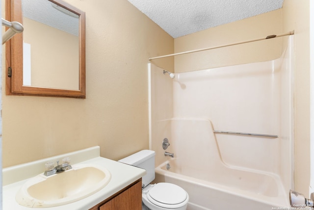 full bathroom with toilet, tub / shower combination, a textured ceiling, and vanity