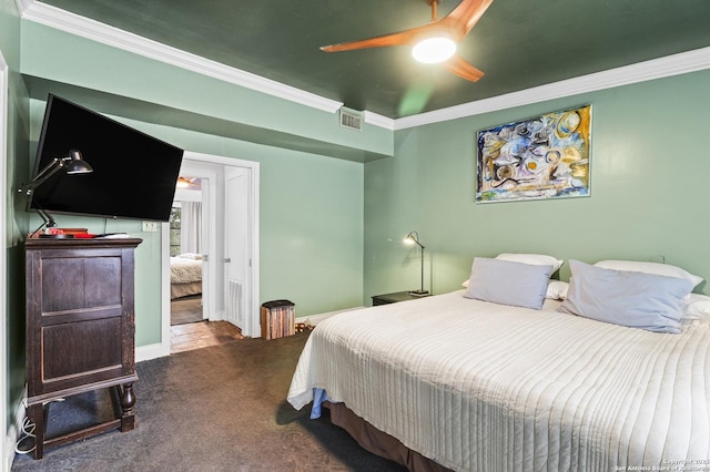 bedroom with visible vents, dark carpet, ornamental molding, ceiling fan, and baseboards