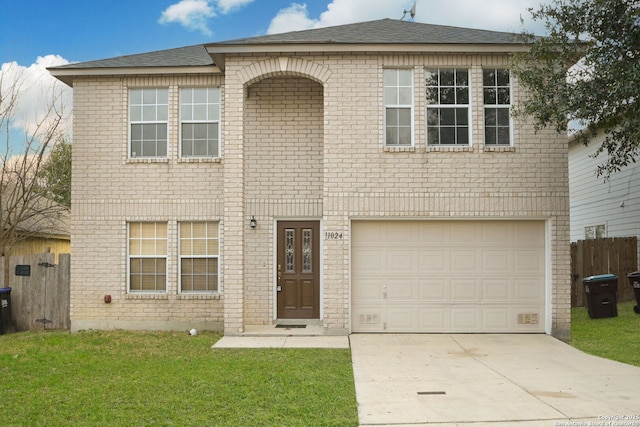 traditional-style home with a garage, driveway, brick siding, and a front yard