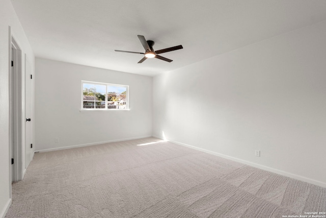 unfurnished room with light carpet, ceiling fan, and baseboards