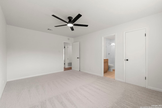 unfurnished bedroom featuring light carpet, baseboards, visible vents, and ensuite bathroom