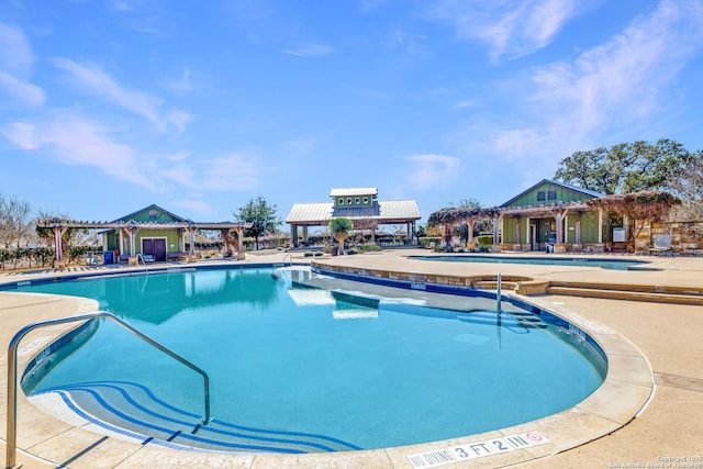 pool featuring a patio area and a pergola