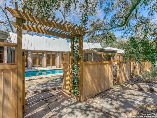 exterior space with french doors, a patio area, fence, and a pergola