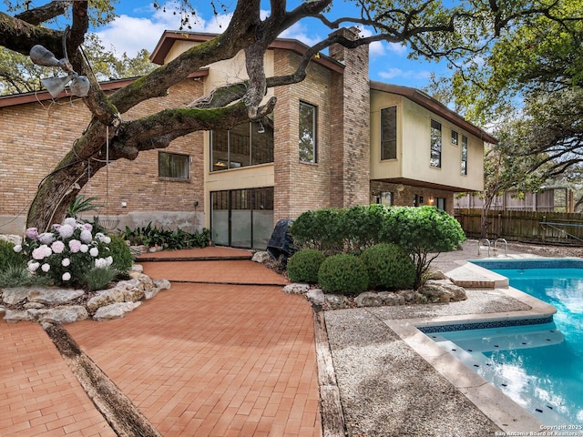 view of property with fence and a fenced in pool