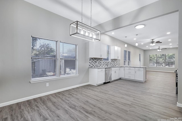 kitchen with decorative backsplash, stainless steel dishwasher, open floor plan, white cabinets, and a peninsula