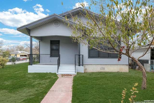 view of front of property with a porch, crawl space, a front yard, and fence