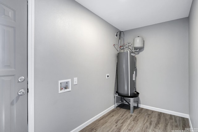 room details with wood finished floors, electric water heater, and baseboards