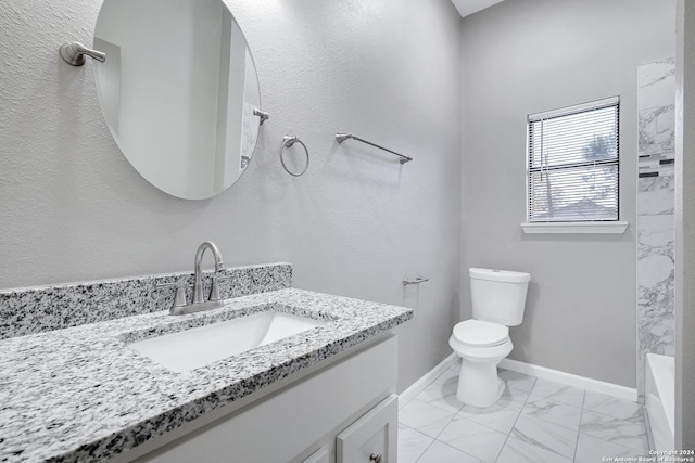 full bath featuring toilet, vanity, baseboards, marble finish floor, and a tub