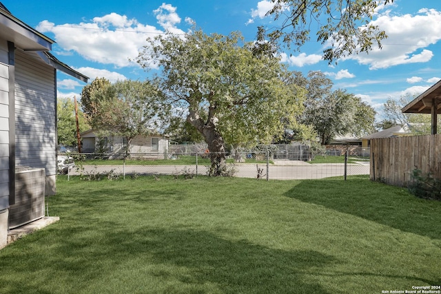 view of yard with cooling unit and fence