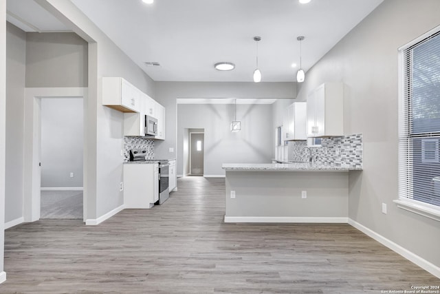 kitchen featuring appliances with stainless steel finishes, white cabinets, visible vents, and baseboards