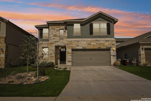 view of front facade with an attached garage, stone siding, concrete driveway, and a front yard