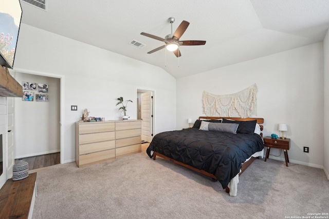 bedroom featuring lofted ceiling, visible vents, and carpet flooring