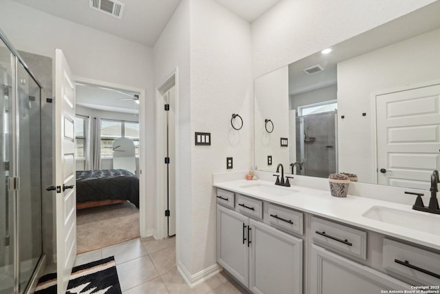 ensuite bathroom featuring double vanity, a stall shower, a sink, and visible vents