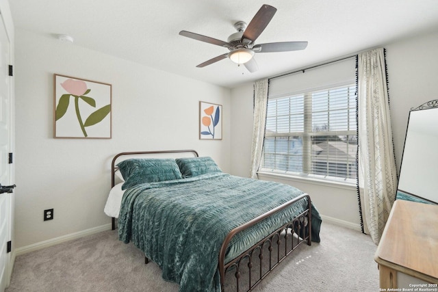 bedroom with a ceiling fan, baseboards, and carpet flooring