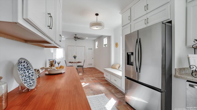 kitchen with ceiling fan, appliances with stainless steel finishes, decorative light fixtures, and white cabinets