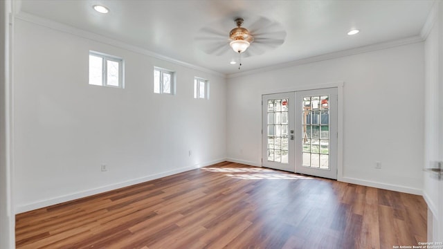 empty room featuring french doors, crown molding, recessed lighting, wood finished floors, and baseboards