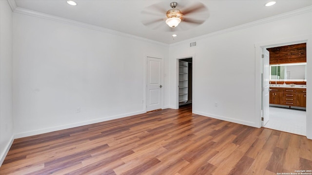 unfurnished bedroom featuring recessed lighting, visible vents, wood finished floors, and ornamental molding