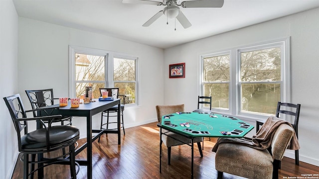 recreation room with ceiling fan, baseboards, and hardwood / wood-style floors